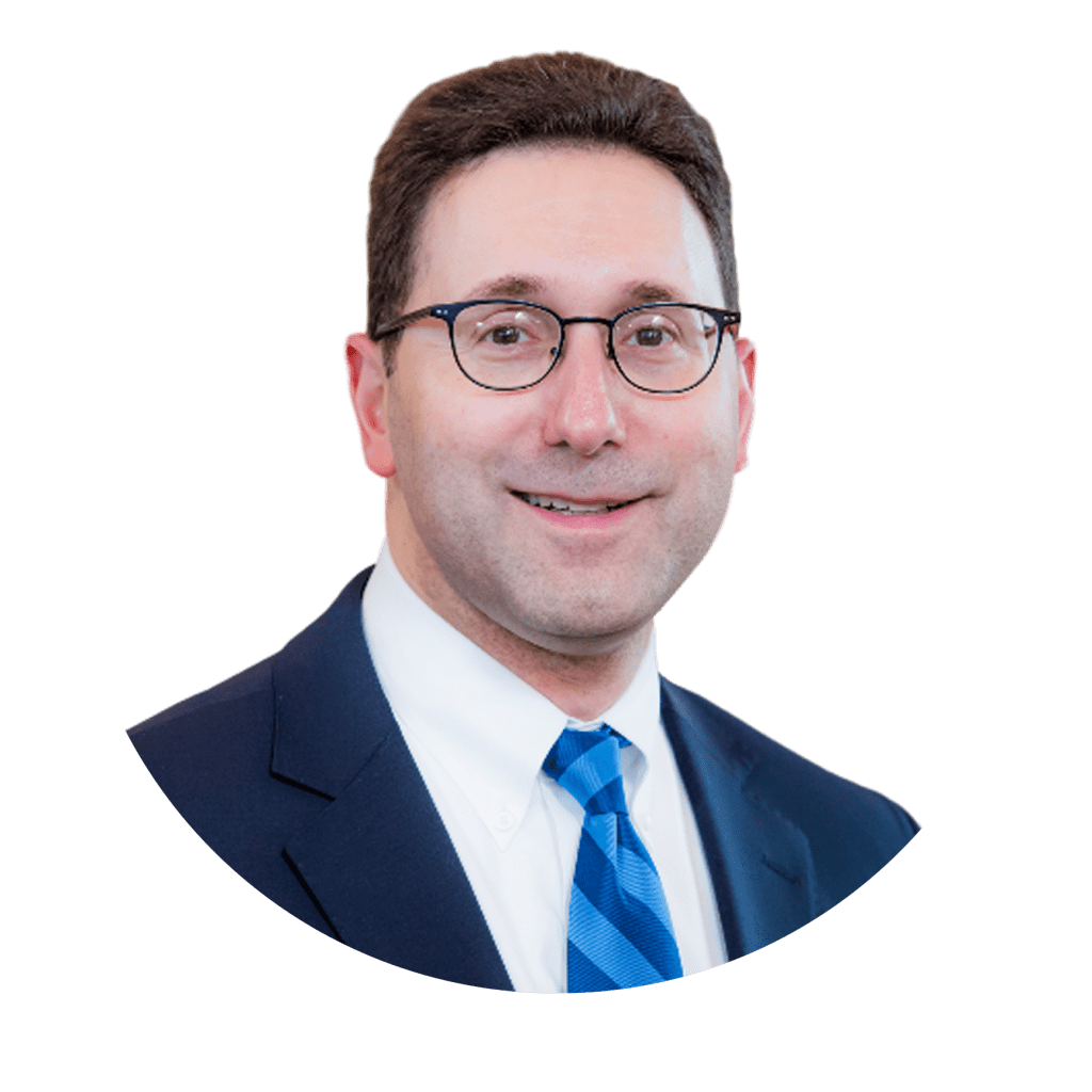 A man in a suit with glasses and a blue tie.